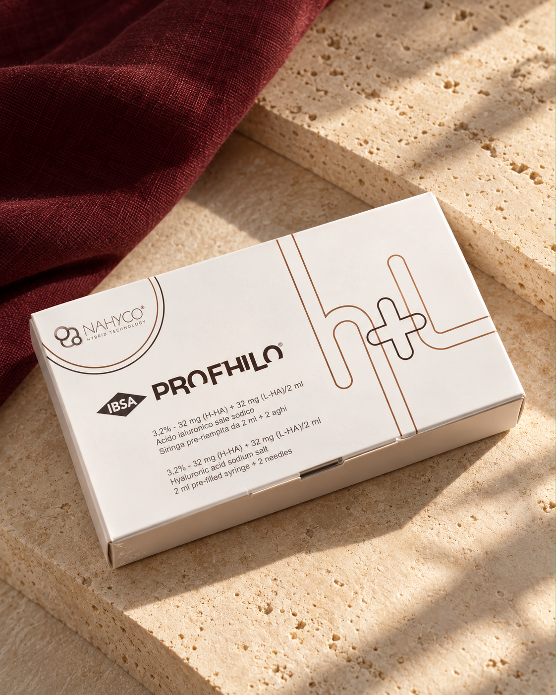 Styled Profhilo packaging on cream travertine with burgundy linen